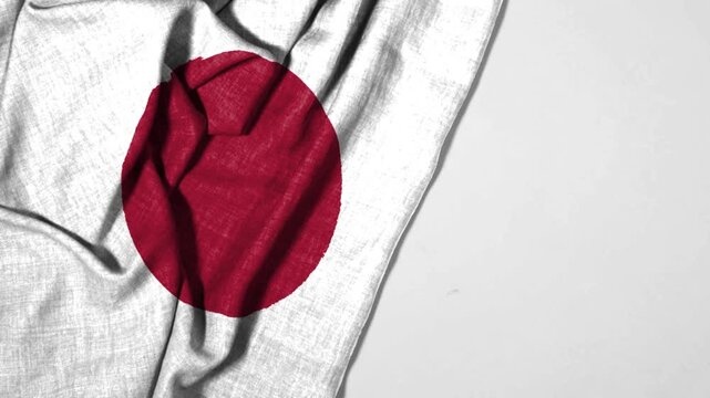Japanese Flag Draped On Wrinkled White Fabric With Red Hinomaru Circle, Minimalist Patriotic Concept