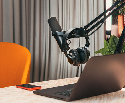 Professional podcast studio equipment microphone headphones laptop