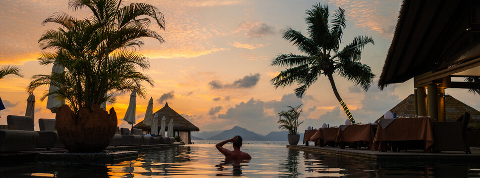 Sunset serenity by the poolside in Seychelles, a perfect tropical getaway