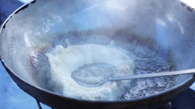 Bhatura deep frying in hot oil 4k footage 