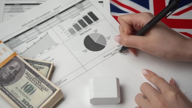 Officer stamps red entered mark on corporate data log after system upload for international British business ensuring no duplicates audit trail regulatory compliance