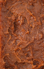 Obraz premium salt caramel paste texture, caramel spreadable cream close up, caramel spread