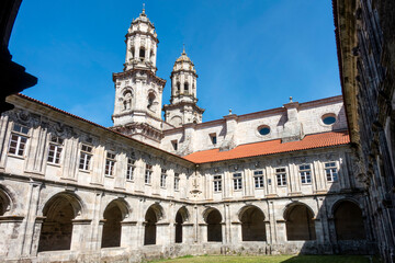 Obraz premium Sobrado dos Monxes, A Coruña, Spain; April 12, 2026: Renaissance Medallions Cloister and Baroque church towers, 16th-17th century, Sobrado dos Monxes Monastery