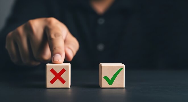 Hand choosing green checkmark block over red X symbol on wooden cubes finger wooden blocks