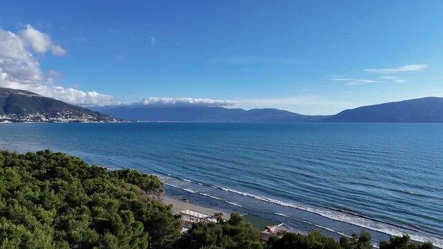 Aerial drone footage of coastal landscape with sea and shoreline.