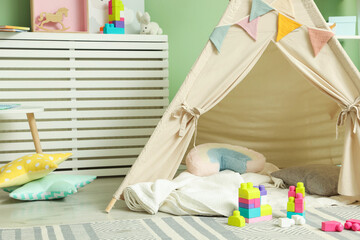 Cute wigwam and building blocks in stylish child's room. Space for text © New Africa