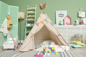Cute wigwam and toys in stylish child's room © New Africa
