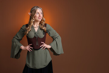 Fototapeta premium Portrait of beautiful elf girl on brown gradient background, space for text