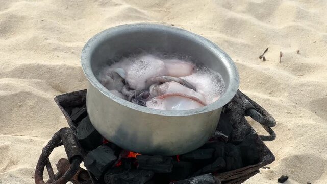 Octopus boiling in pot traditional seafood preparation Zanzibar