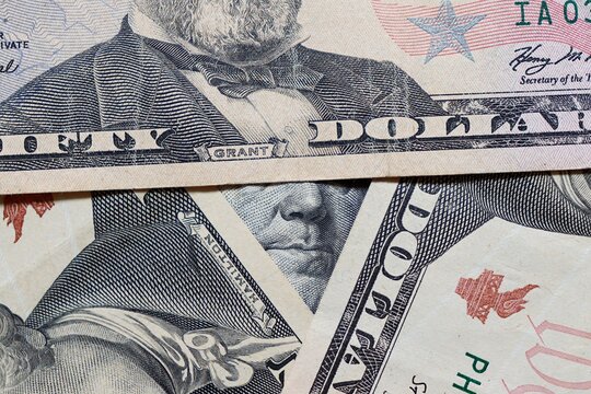 US Dollar bills close-up. Pyramid shape of stacked US Dollar bills. 