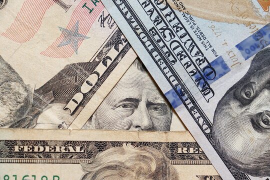 Closeup on Grant portrait eyes and pyramid shape of stacked US Dollar bills. 50 dollars. 