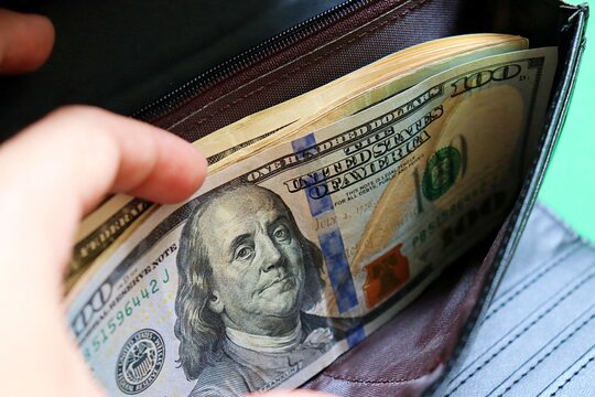 United States Dollar banknotes in a wallet. US dollar bills. American money. 