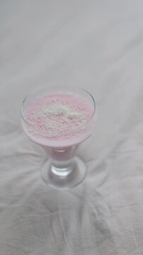 Close up of pink computer mouse next to cake and pudding