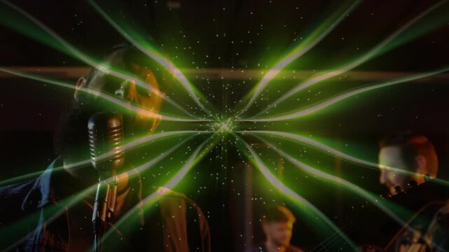 Band performing in dim music room, projection pulsing starburst and refracting band for practice