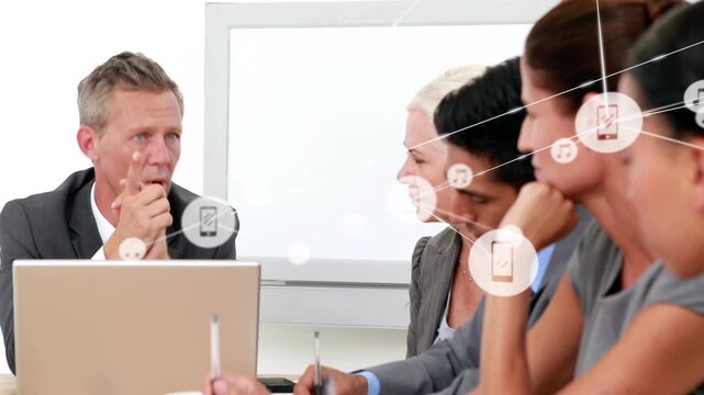 Exec starting business pitch, gesturing at laptop, team taking notes, icons demonstrating network