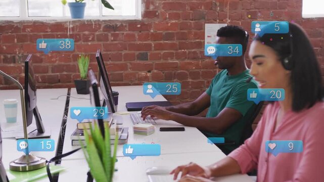 Notifications rising around monitors, pair responding typing and speaking, managing social media