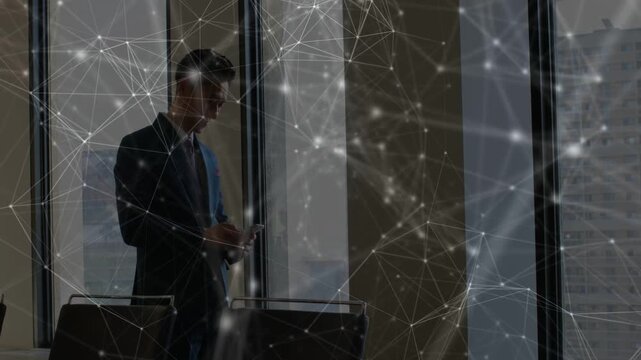 Male exec checking phone, scrolling for updates, network overlay shifting over phone and skyline