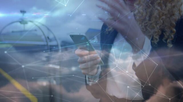 Woman tapping phone screen causing network cloud overlay on transit for work, camera pulling back
