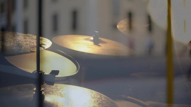 Passing walker in glass leading drummer hands entering striking cymbals with sticks in studio
