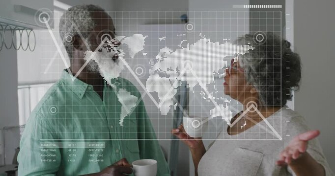 Senior woman gesturing and explaining global data in kitchen, causing HUD map and graph animating