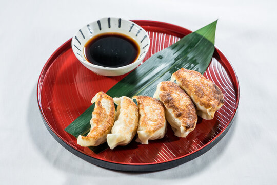 Pan fried dumplings with dipping sauce