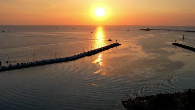Aerial view of busy port of Duong Dong town with boats returning from a long day of fishing at sunset golden hour sun going down on the horizon Phu Quoc Island in South Vietnam