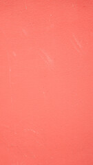 Fototapeta premium The surface of the house's plaster wall is painted red, serving as a powerful backdrop.