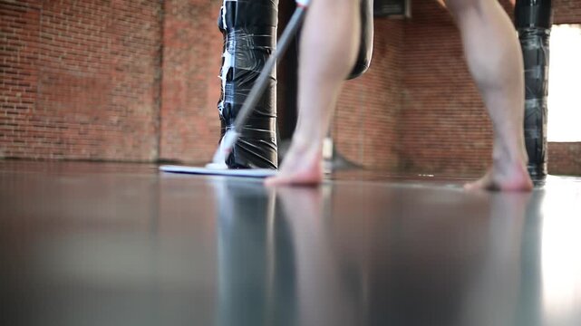 Gym mat cleaning close up low angle view, mopping the floor before practice, selective focus video