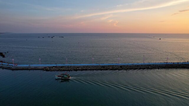 Aerial view of busy port of Duong Dong town with boats returning from a long day of fishing at sunset golden hour sun going down on the horizon Phu Quoc Island in South Vietnam
