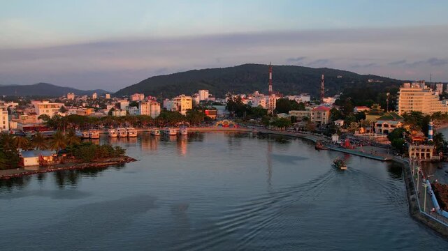 Aerial view of busy port of Duong Dong town with boats returning from a long day of fishing at sunset golden hour sun going down on the horizon Phu Quoc Island in South Vietnam