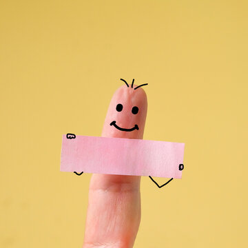 Funny finger toon holding blank bunner on color background.