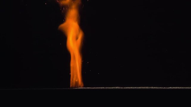 Burning Gunpowder on Black. A thin horizontal strip of gunpowder ignites at one end and gradually burns away against a black background