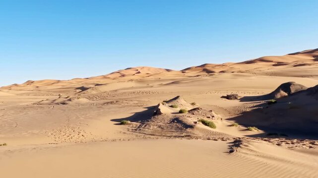 Stone well in the sandy erg chebbi desert landscape with beautiful dunes under a clear blue sky in merzouga, morocco