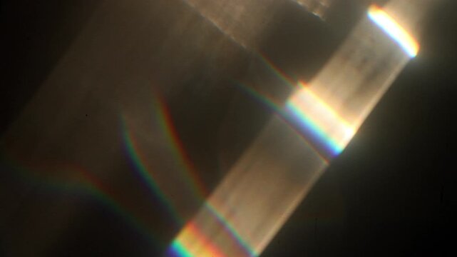 Moving Abstract Bokeh Spectrum Light, lens flare, leaking reflection of glass, crystal, defocused multicolor rainbow rays background