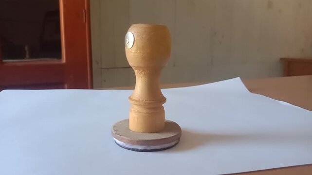 A wooden stamp on a piece of white paper