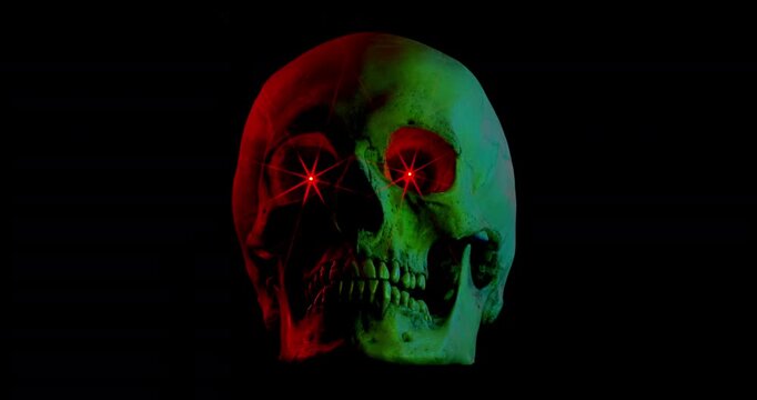 Neon Skull with Glowing Eyes. Video of motionless human skull with bright red glowing eyes and shifting colorful neon lights on black background.