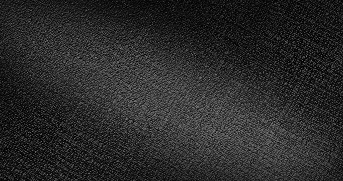 Black Texture Abstract. Slow smooth rotation of dark textured surface with fine grain pattern gently moving under dramatic directional light creating subtle highlights and deep shadows.