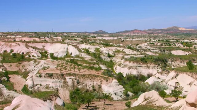 An aerial or high-angle view of the majestic and unusual rocky formations in Pigeon Valley (G&uuml;vercinlik Vadisi), a popular attraction in the Cappadocia region of Turkey. The unique tuff rock landscape