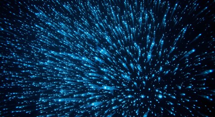 Fototapeta premium Abstract glowing blue particles exploding outwards in darkness with bokeh effect