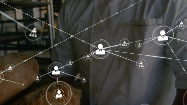 Baker holding tray and smiling in bakery, icon appearing over loaves and generating network overlay