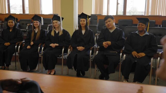 Multinational students listen to a classmate's speech. 