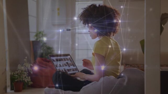 Woman sitting browsing laptop thumbnails for review, tech overlay brightening, settling over scene