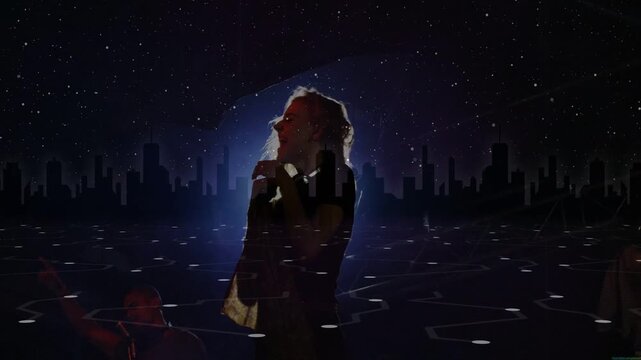 Concert singer performing head flip to camera creating halo singing into mic amid projected skyline