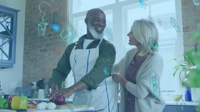 Man chopping onions, woman draping towel and touching arm activating floating teal icons cooking
