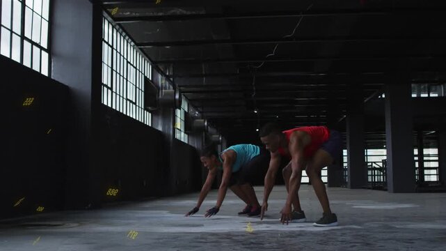 Training partners following yellow countdown and doing burpees for fitness by tall windows