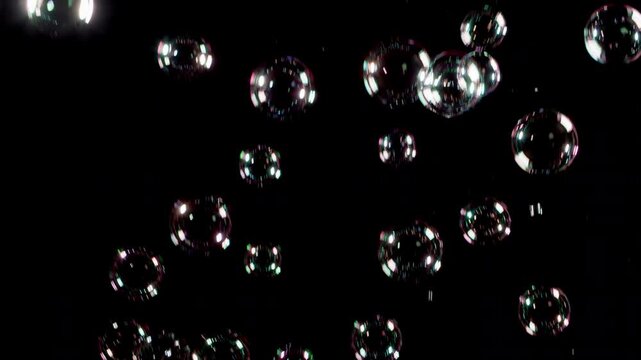 Long shot of real soap bubbles falling with black background , easy blend into your compositions by screen mode.