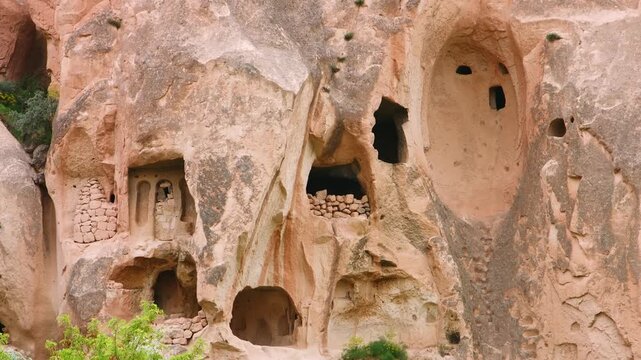 Captivating view of ancient rock-cut churches and cave residences carved into the unique geological formations of the Zelve Valley area in Cappadocia, Turkey, showcasing historical significance and na