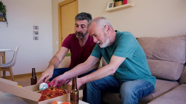 Father and son enjoying pizza together while watching football
