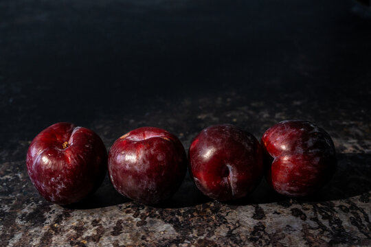 Plums on a dark surface 