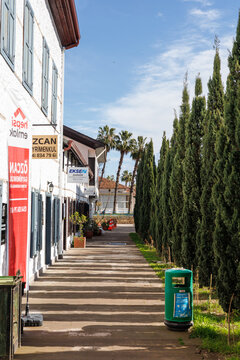 Pedestrian walkway with trees and signage on January 29, 2023 in Turkey, the city of Finike